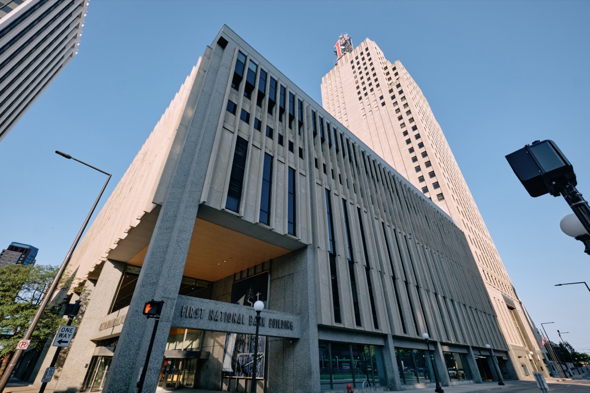 The First National Bank Building's limestone tower and red 1st sign above the Minnesota Street entrance