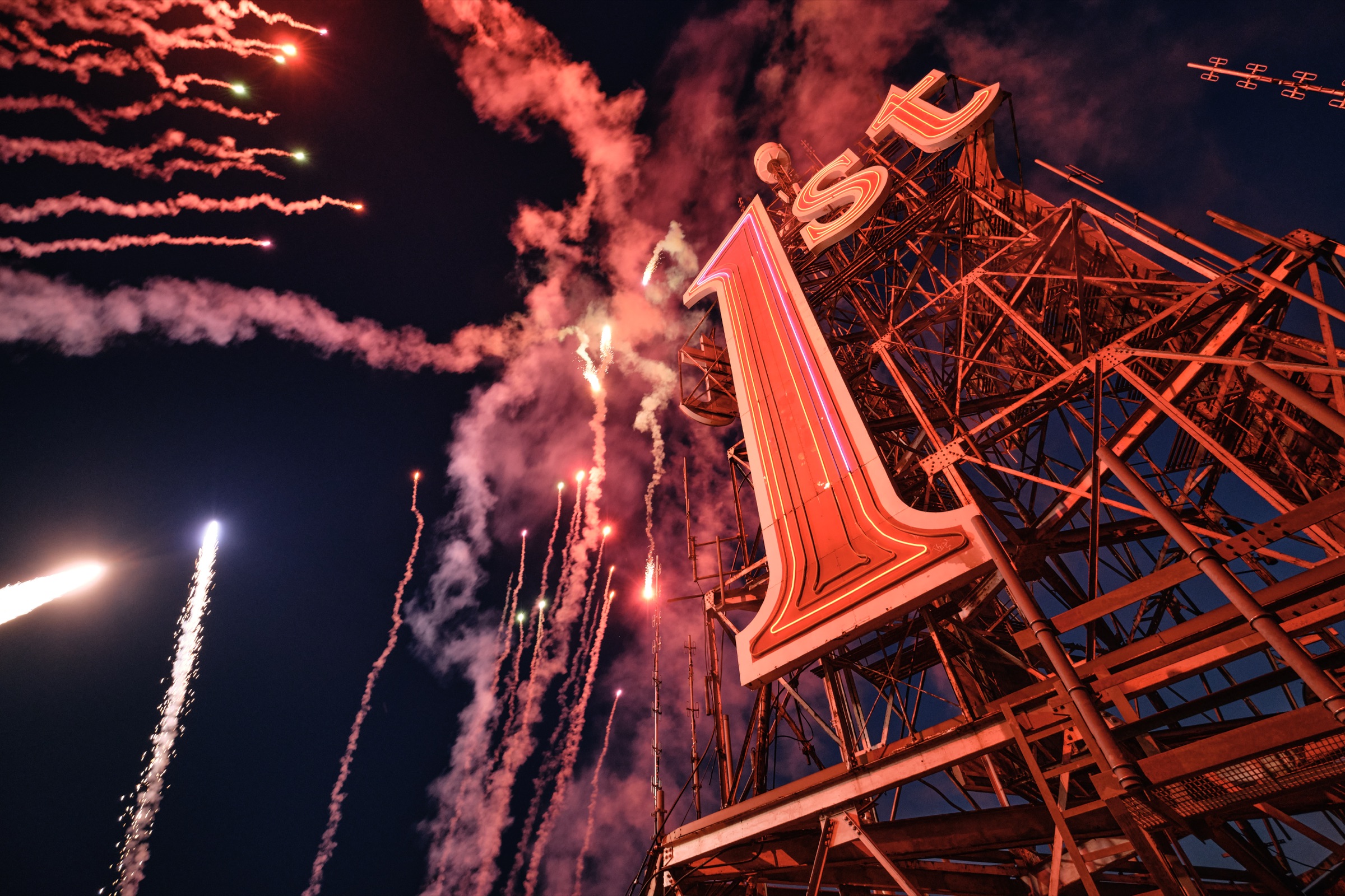Fireworks over the relit 1st sign atop the West Tower